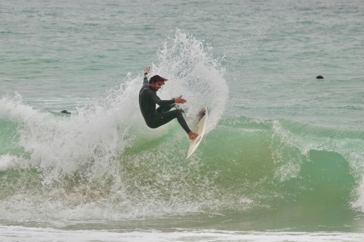 Surfer riding a green wave