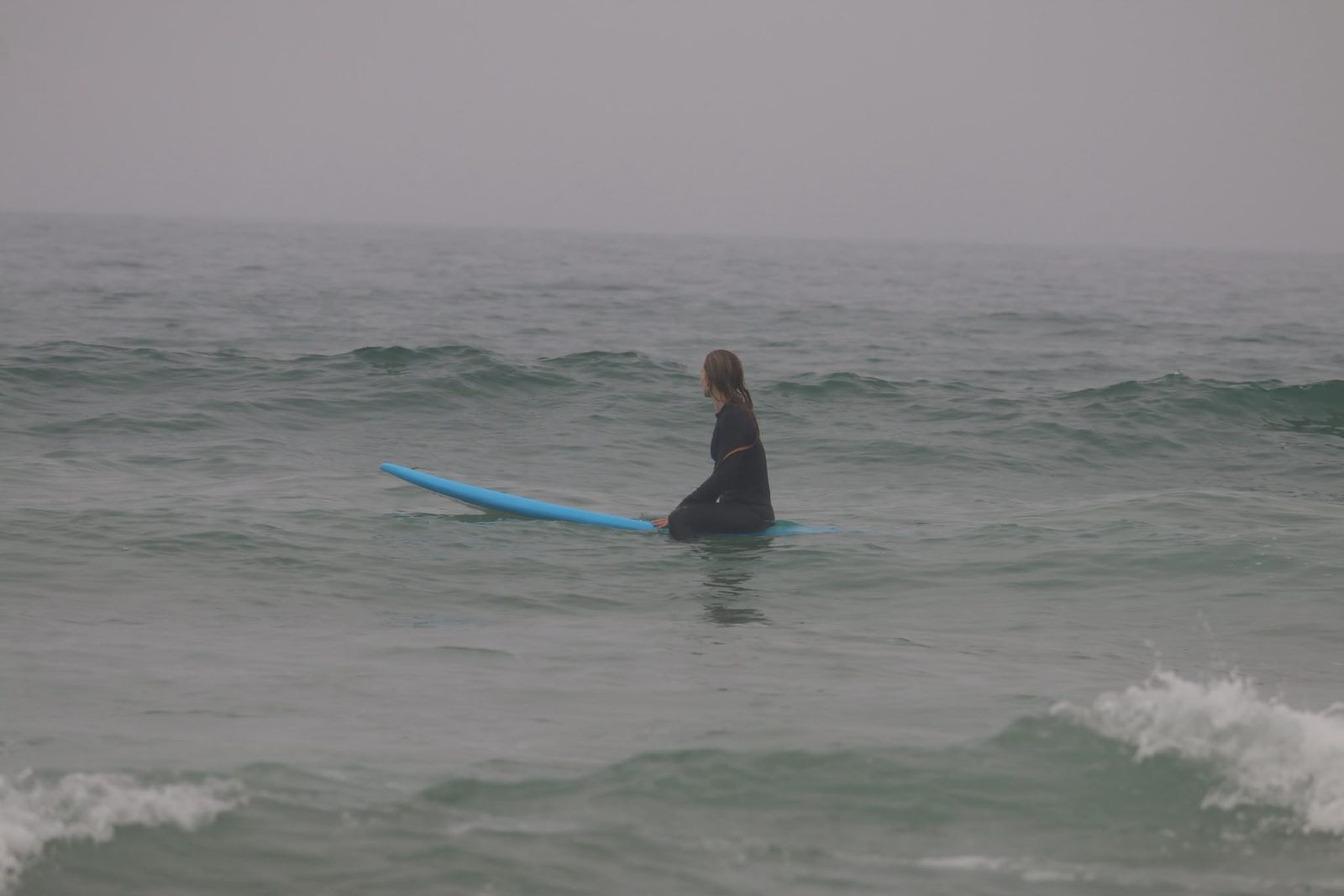 A student sitting on the board waiting for the next set
