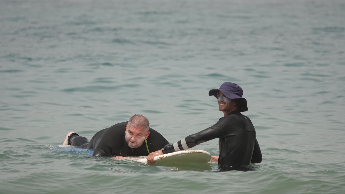 Beginner student paddling with the coach