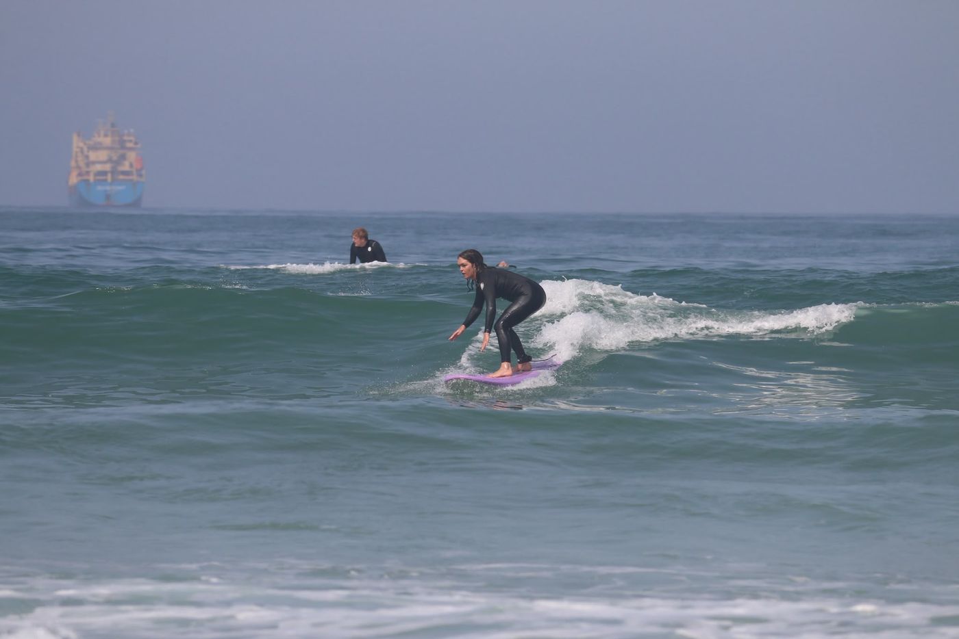 Surfer riding a green wave