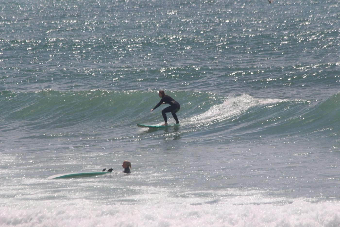 Student surfing an unbroken wave