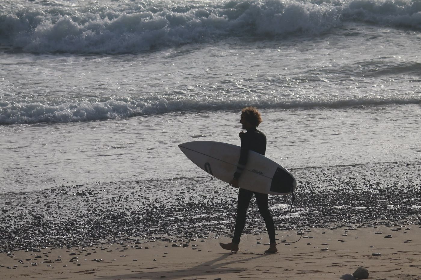 Surfer walking to the lineup