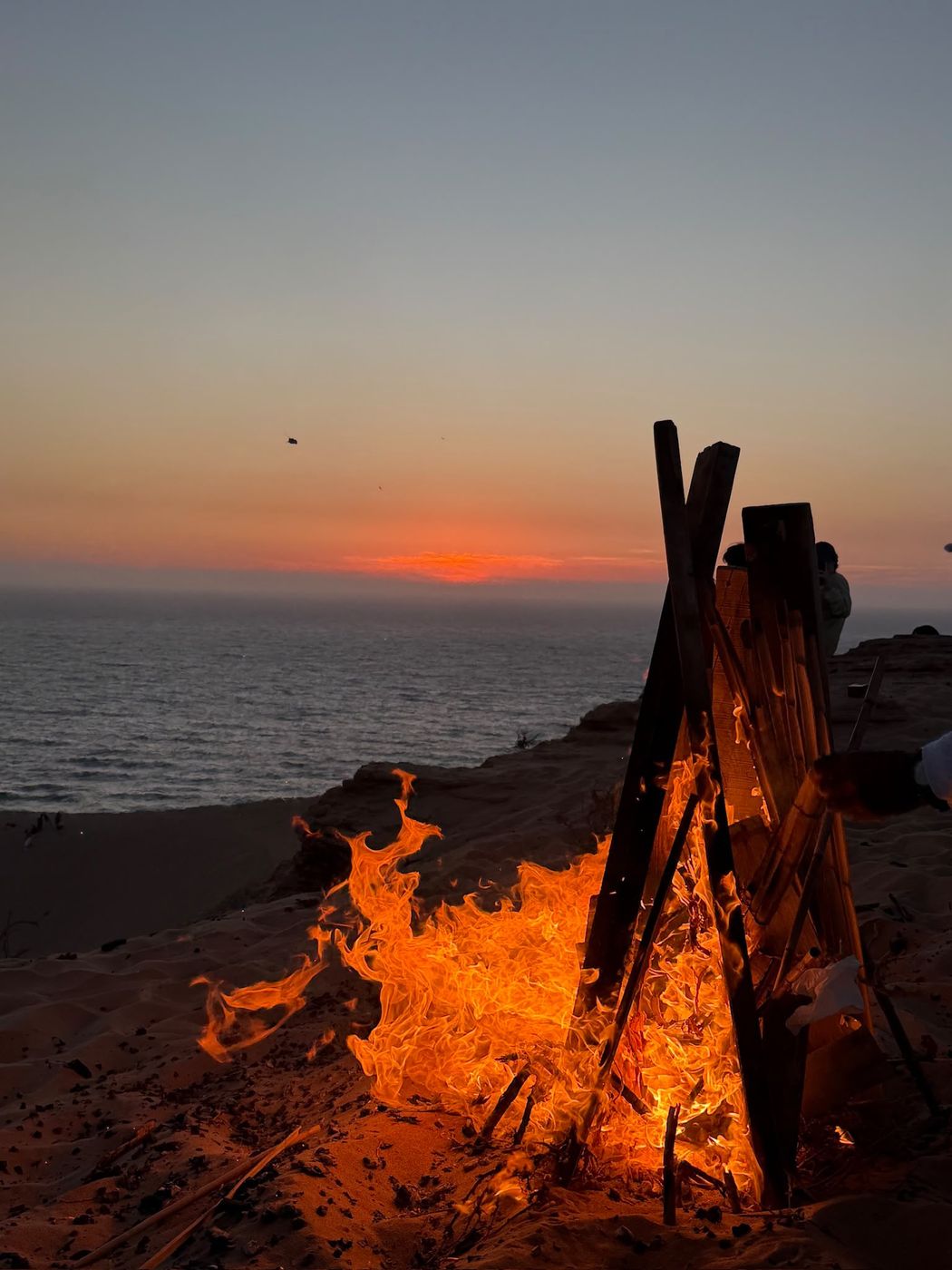 Campfire at sunset on the dunes trip